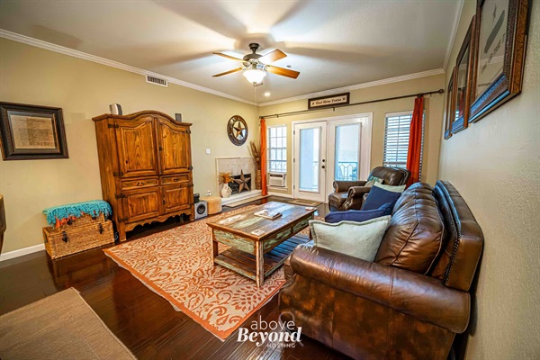 Comfortable living area with leather seating, large windows, and direct access to the lakeview balcony