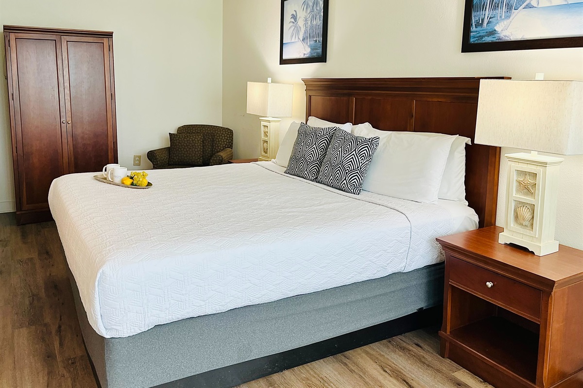 Drift into tranquility on a bed near the balcony of our oceanfront suite, where the gentle ocean breeze and stunning vistas create a peaceful haven.