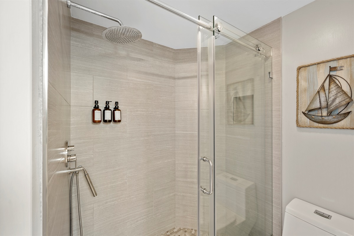 Master walk-in shower has a rain shower head and shower wand.