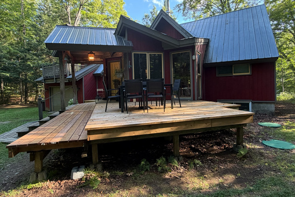 Cottage side deck with seating for outdoor dining