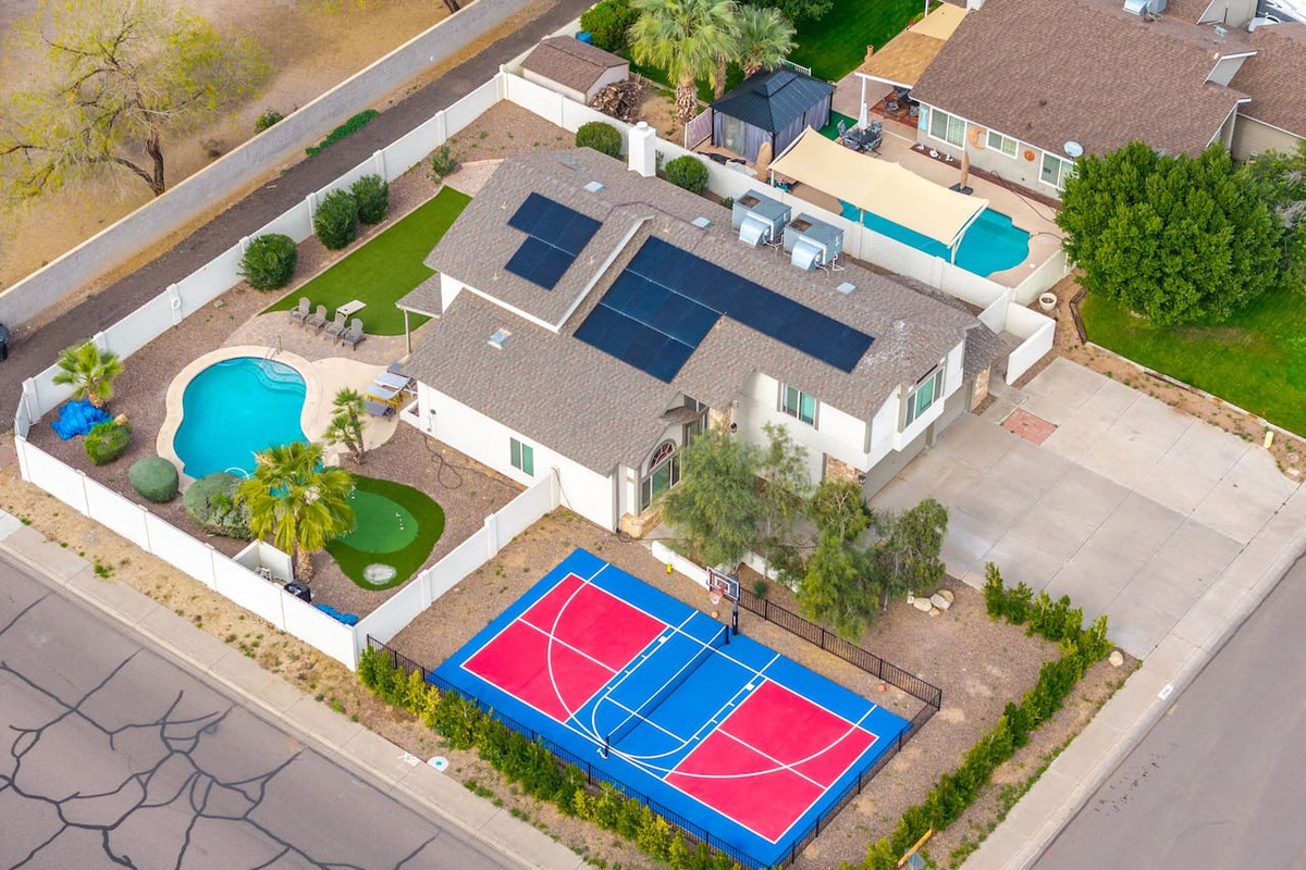 A backyard built for play — pool, court, and green all in one stunning layout.