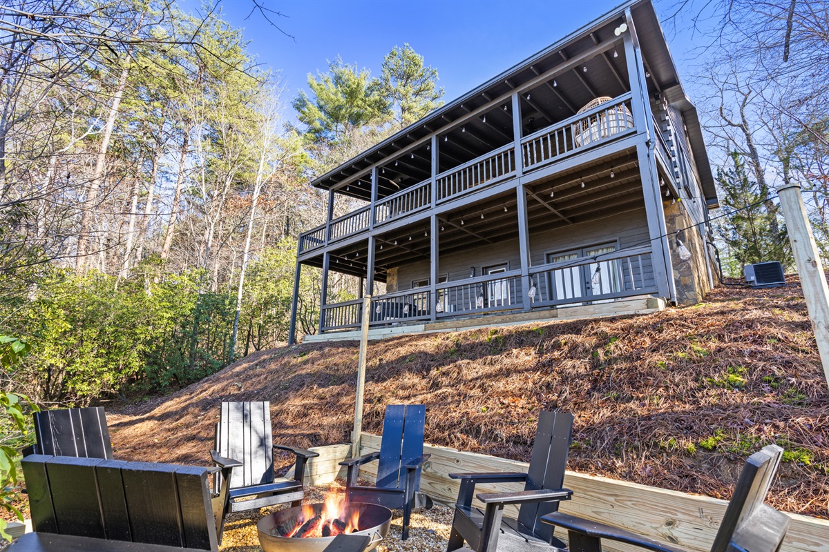 Gather around the fire pit and enjoy the serene forest views, just steps away from this spacious two-story cabin retreat.