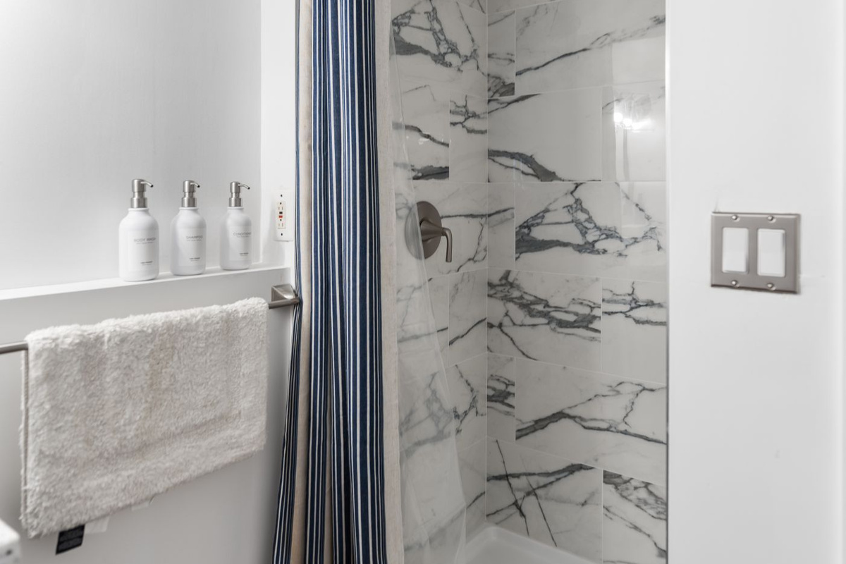 Lower level bathroom includes a full tiled shower