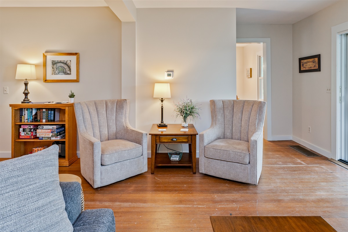 Enjoy quiet moments in this charming corner with plush armchairs, perfect for reading or sipping coffee.