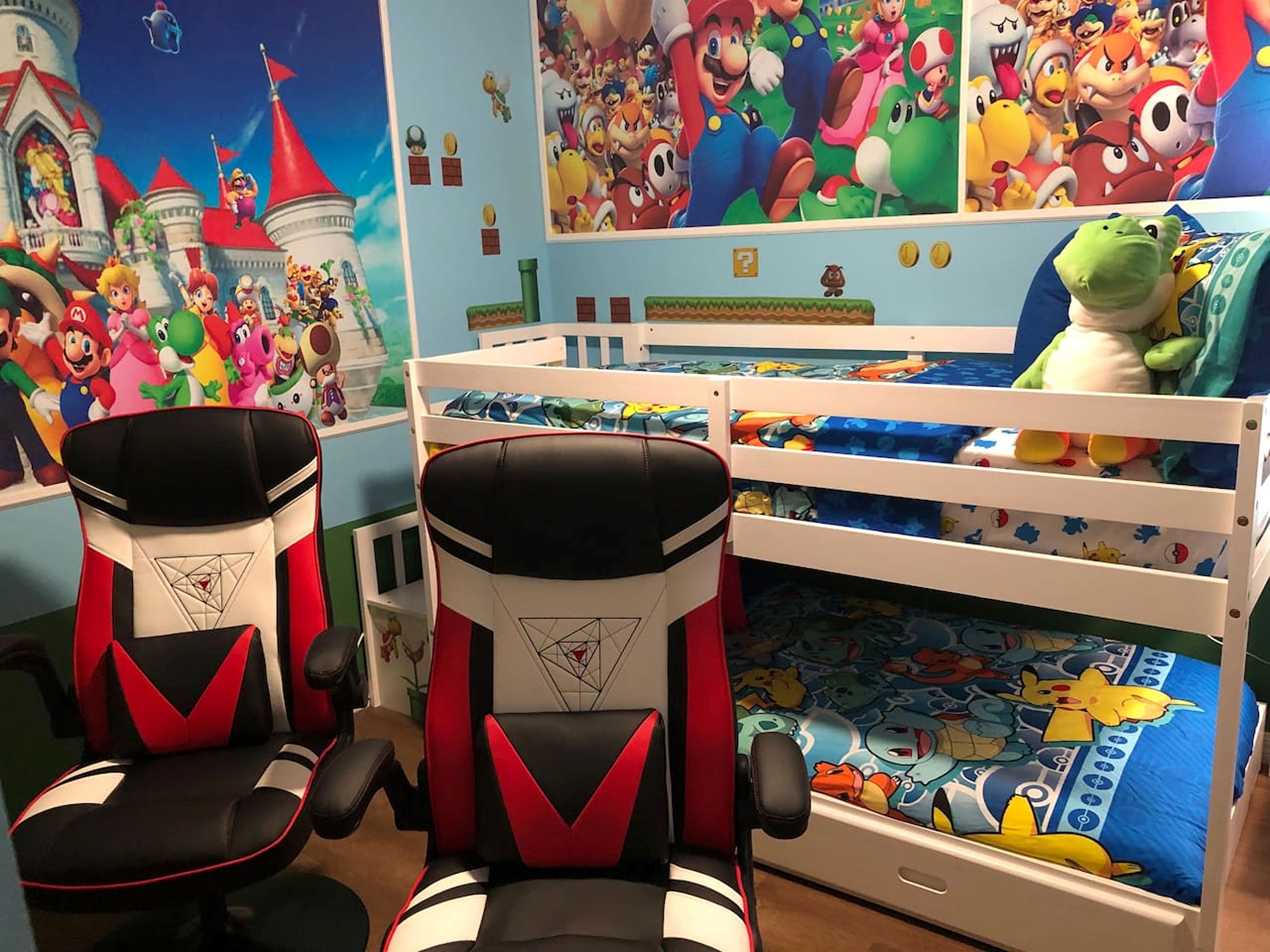 Twin/twin bunkbed room with Xbox and two gaming chairs with Mario decor.