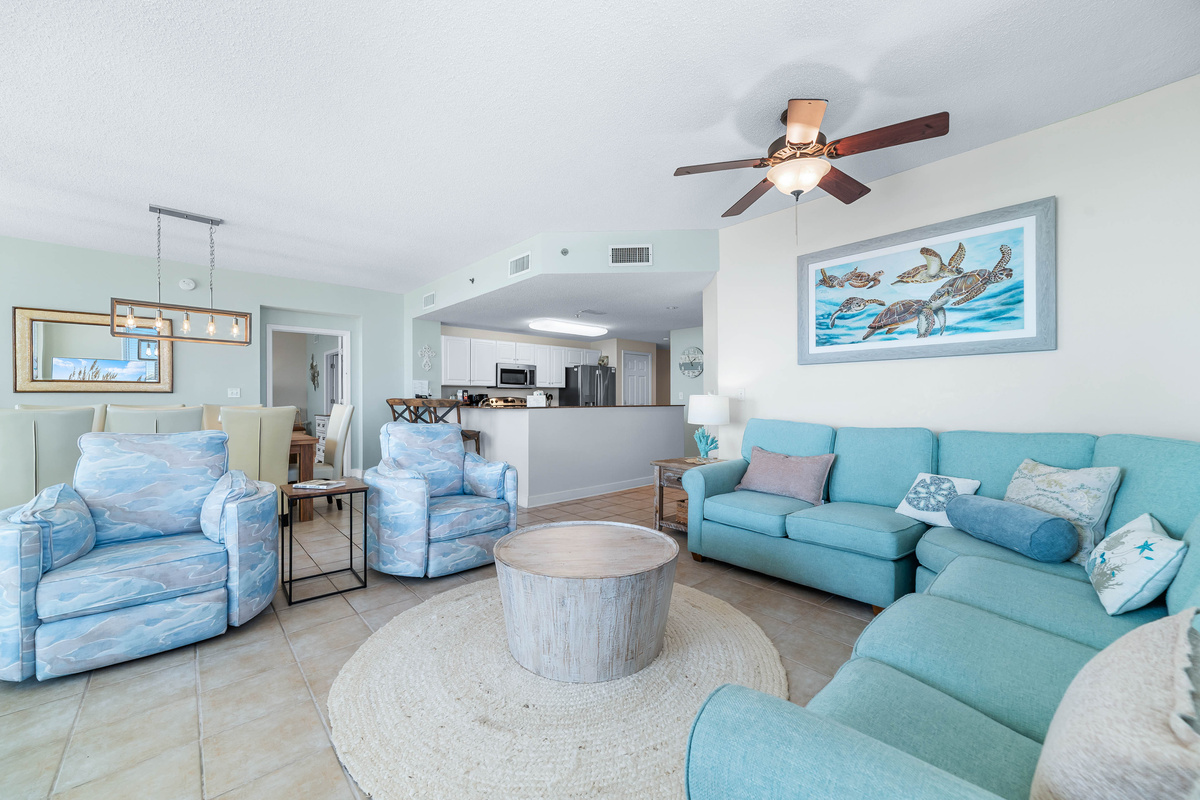 Step into a serene living space featuring a unique starfish-adorned console, plush seating, and expansive sliding doors leading to a scenic balcony.