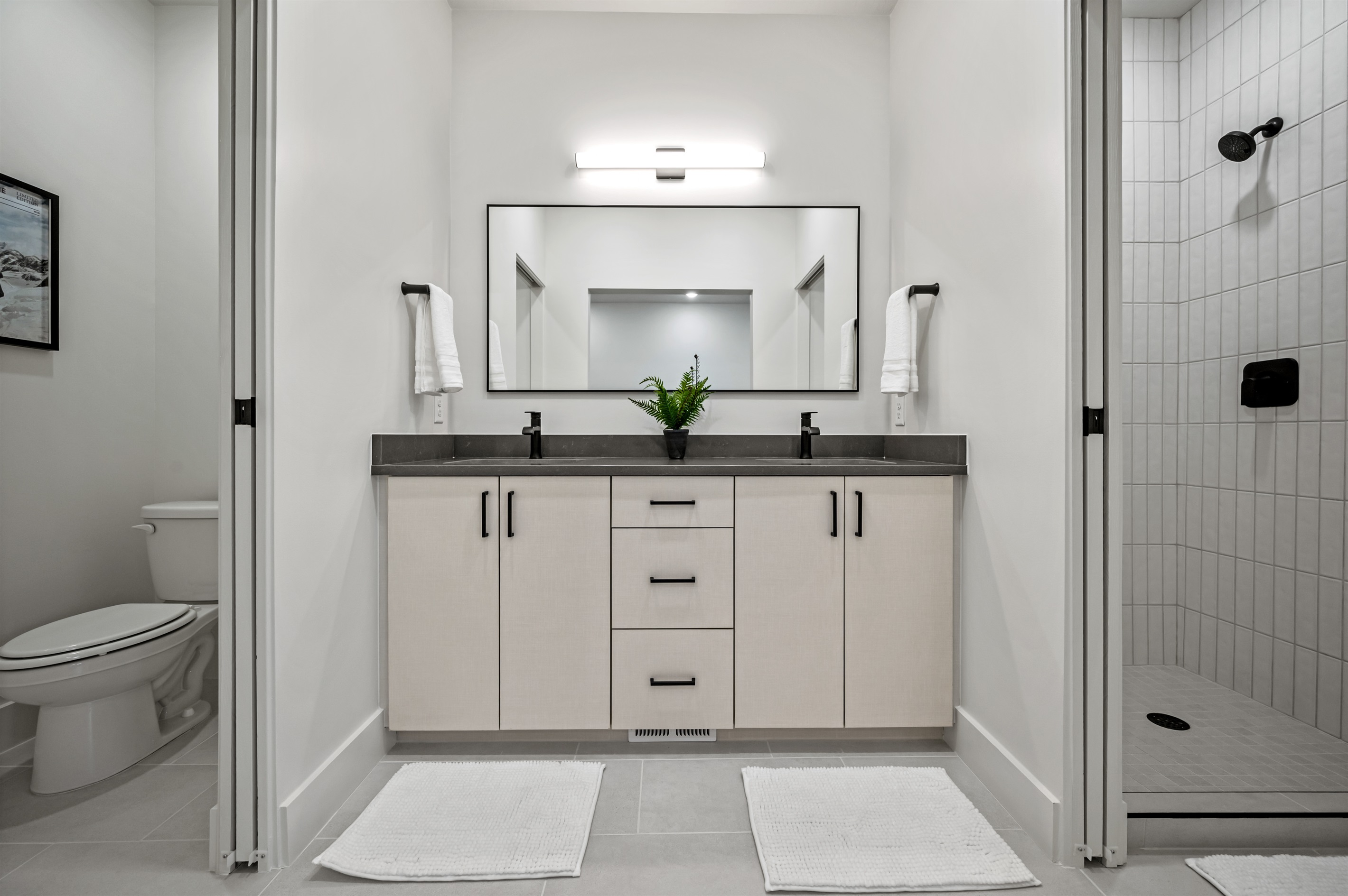 Dual sinks, sleek countertops, and a spacious mirror — perfect for getting ready in style.