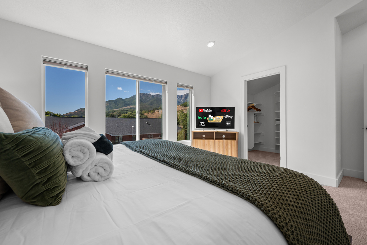 Soft bedding and a bright, airy layout make this bedroom a comfortable place to recharge.