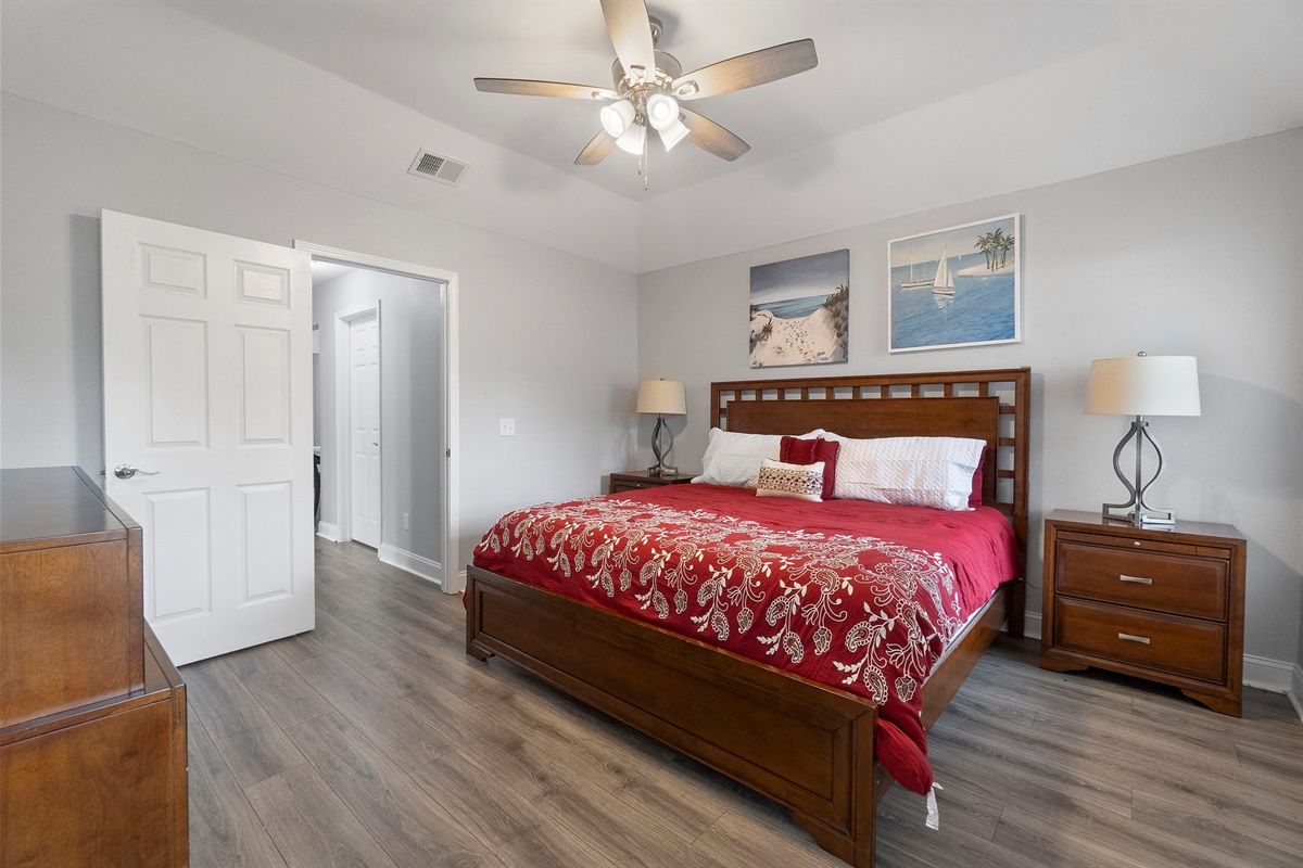 This beautifully designed bedroom blends modern elegance with cozy coastal décor. Enjoy restful nights in the king-size bed, ample storage in the dresser and nightstands, and a ceiling fan to keep things cool and breezy.