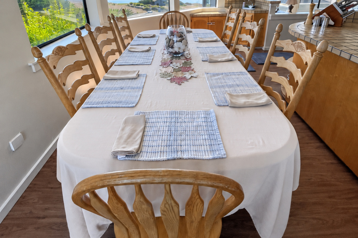 Dining table with Ocean and Fairway views seats 8-10. Extra chairs in guest bdrms