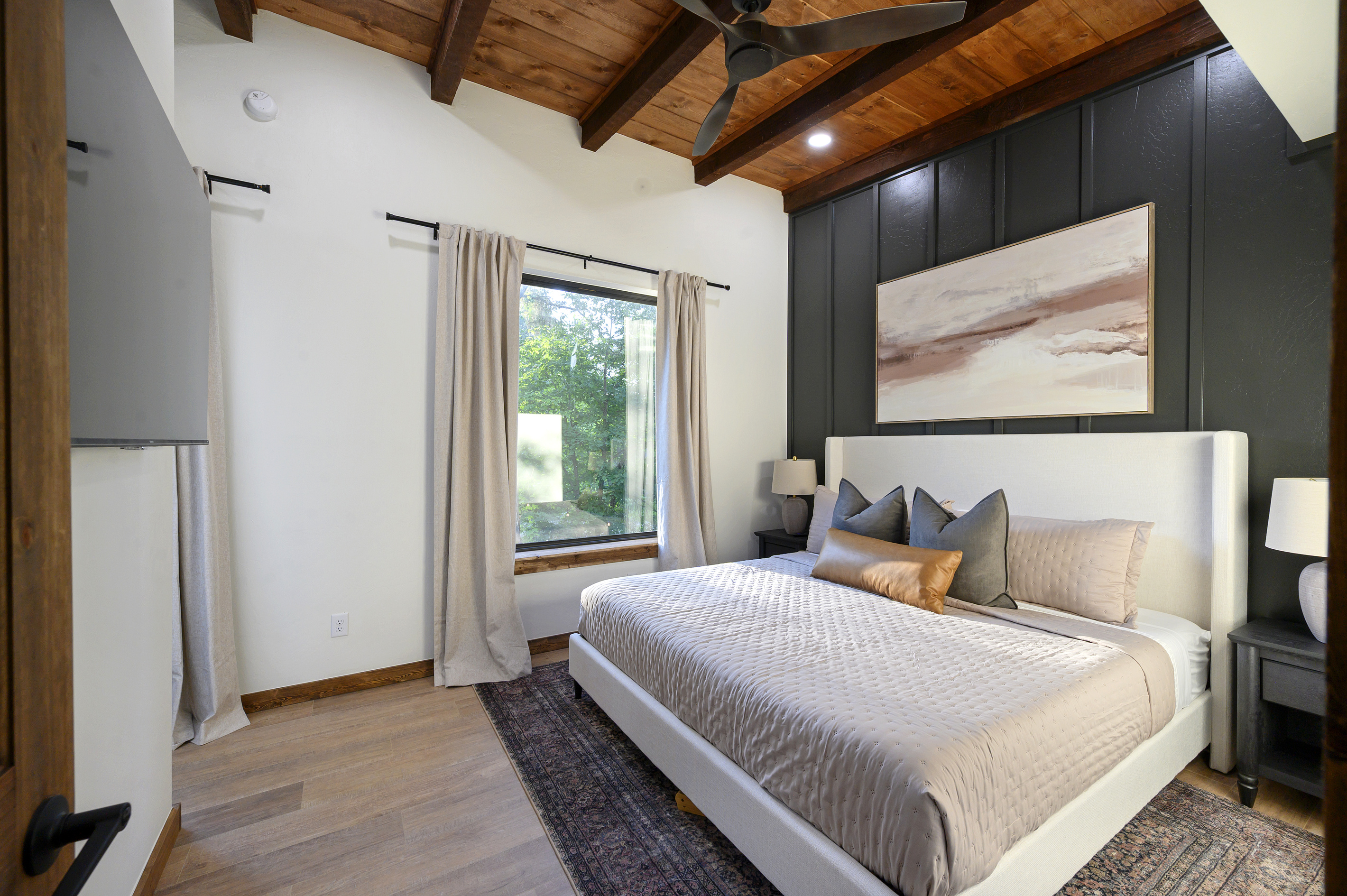 A peaceful king bedroom with warm wood ceilings, tailored finishes and treetop views, giving adults a quiet retreat away from the fun.
