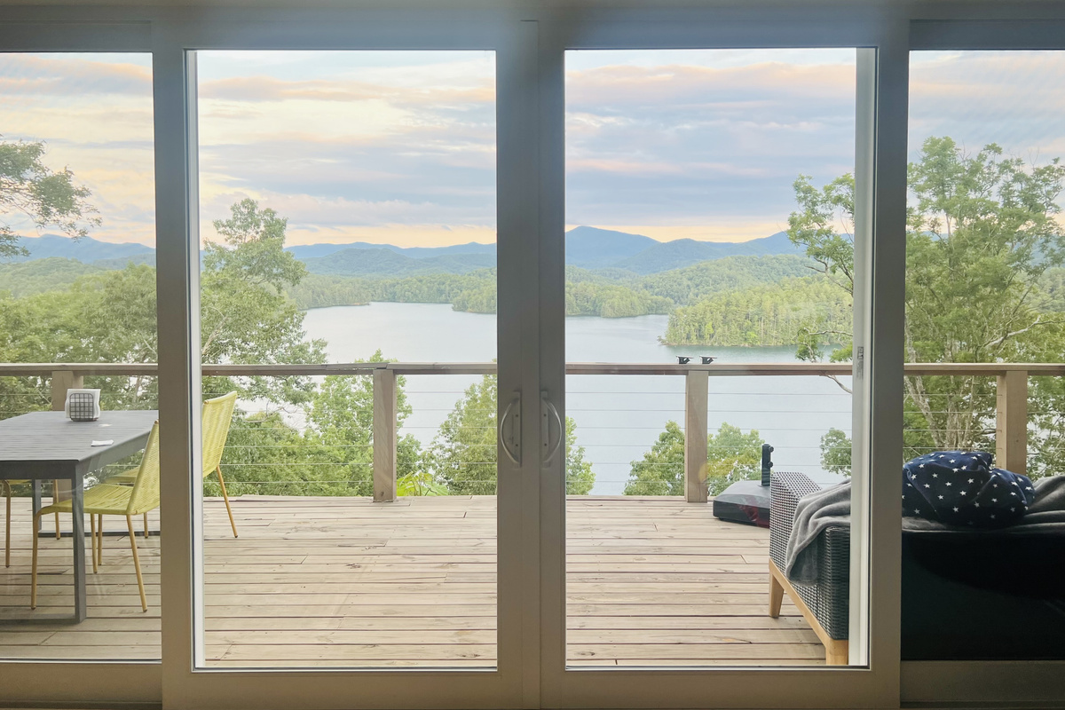 The best seat in the house. ☕🏔️ Wake up to sweeping views of Lake Santeetlah and the Smoky Mountains from the comfort of Hidden Point House.