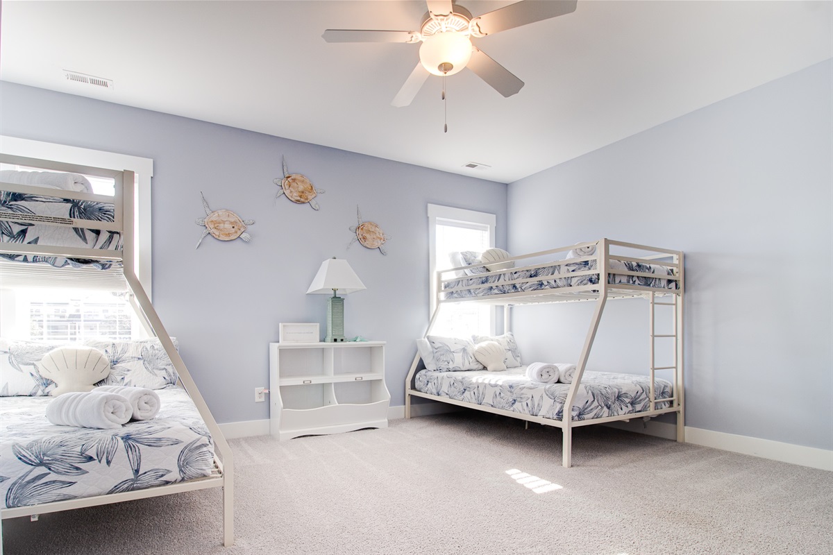 Two Twin-over-Queen bunk beds make this room perfect for kids, teens, or mixed-age groups
