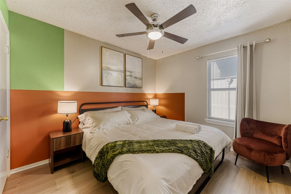 Inviting bedroom with warm colors, modern furnishings, and a cozy, relaxing feel.