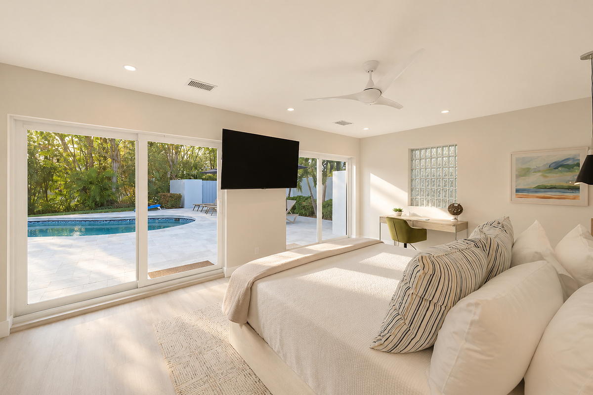 Wake up to pool views from this king bedroom, with a wall-mounted TV and workspace for a longer, more comfortable Delray Beach stay.