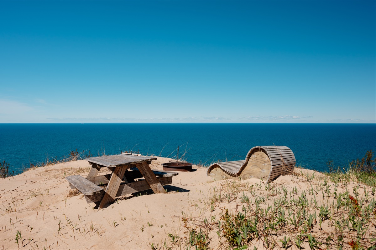 Private dune-top fire pit area featuring breathtaking panoramic views of Lake Michigan, the perfect spot for sunsets, stargazing, and cozy evenings by the fire.