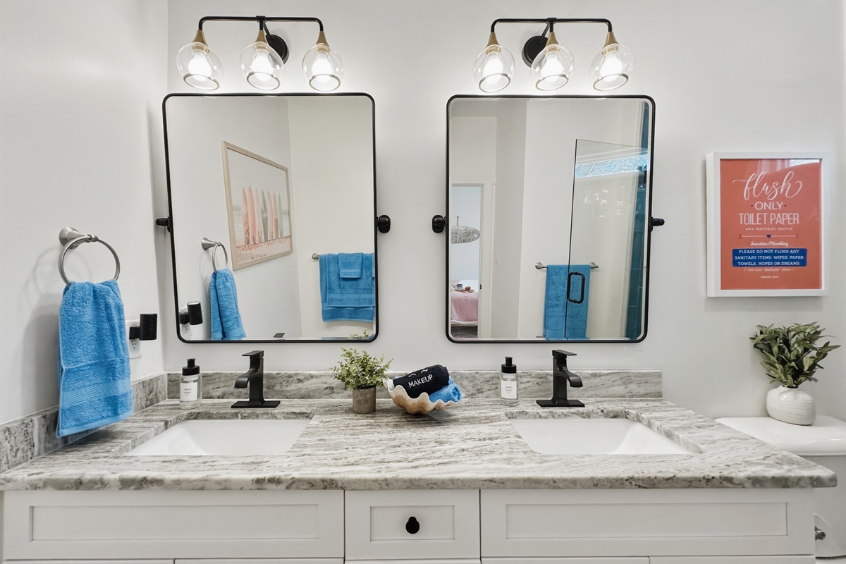 The en-suite bathroom has a bright double vanity.
