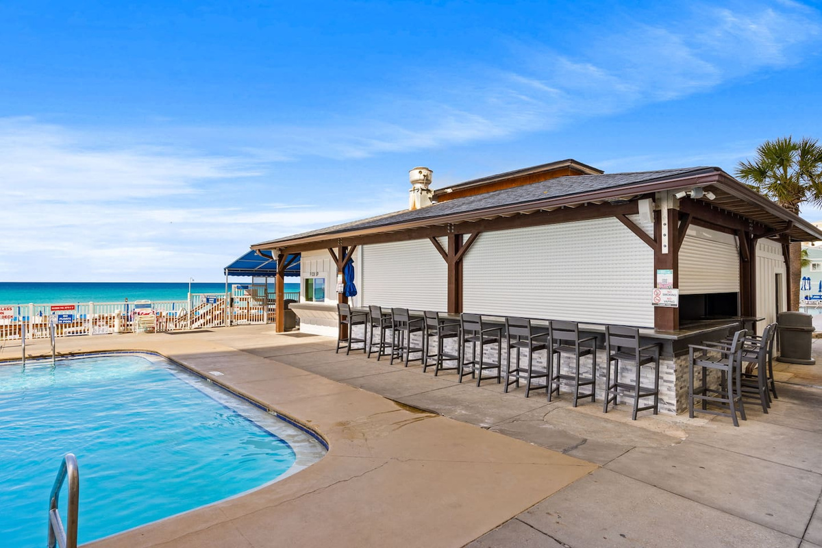 Enjoy food and drinks from The Sandbar, located down on the pool deck between the two pools