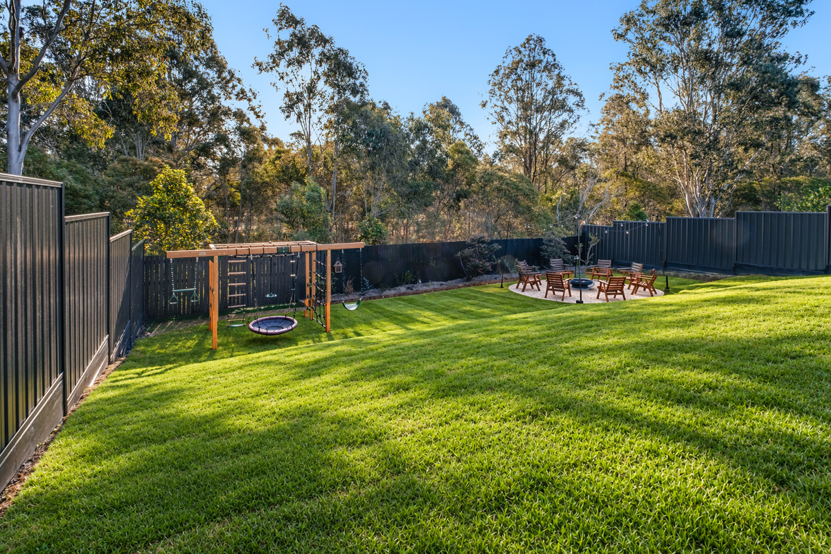 The backyard offers something for everyone, with a large lawn, fire pit seating, outdoor entertaining space and kids’ play area.