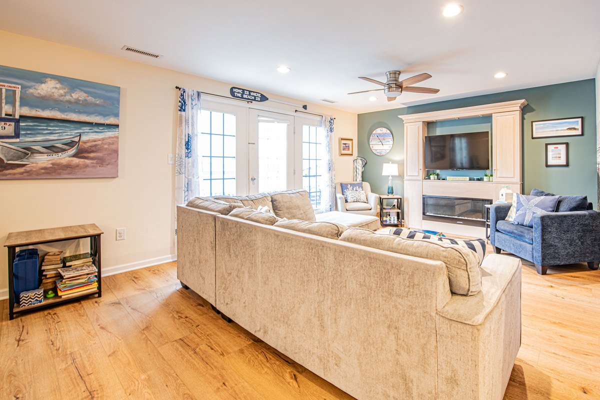 Living Area with Sectional Sofa, Fireplace, TV, and Patio Doors