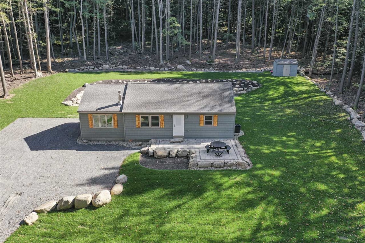 Front of House that shows the boulder retaining wall and brand new paver patio