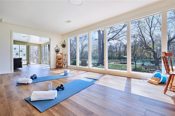 Sun room at The Little Red Riviera with floor-to-ceiling river views
