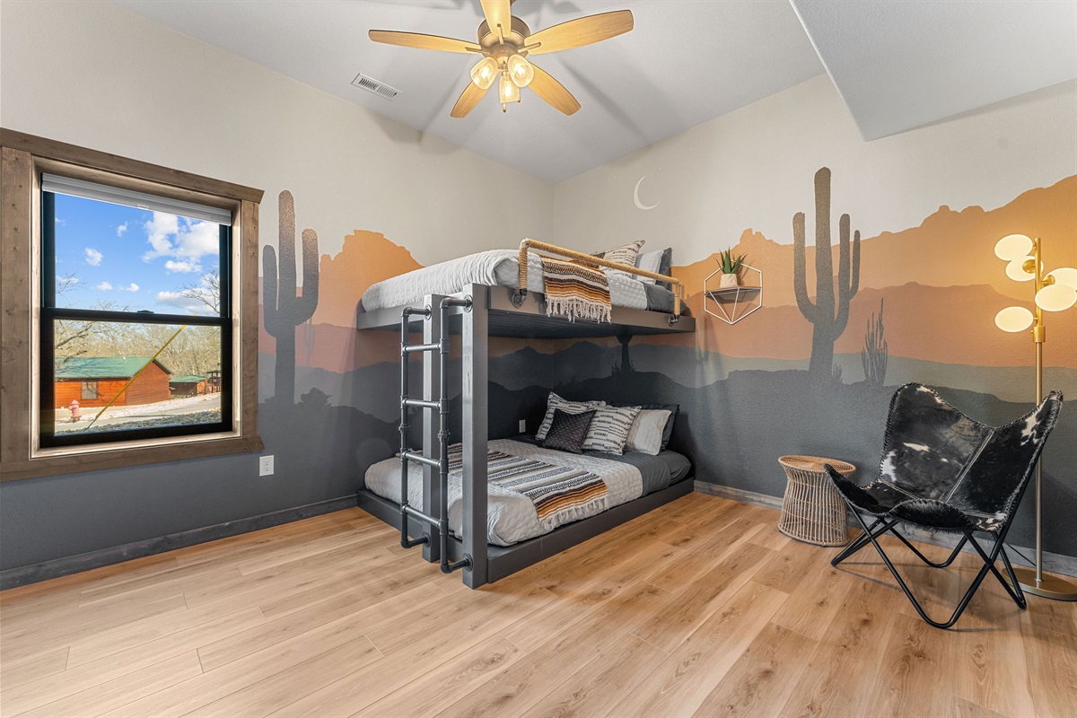 🌵 Cozy bunk room with custom mural + queen-over-queen beds for the whole crew