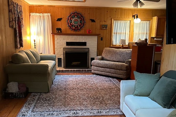 Cozy living room with two sleeper sofas — one folds into a twin bed, the other a cot-size. Perfect for extra guests! Fresh bedding is stored in the closet. Ideal for relaxing after a day exploring the orchards, trails, or lakes nearby.