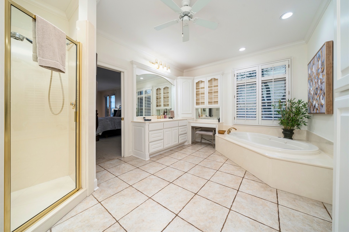 [Primary Bathroom] The Primary Bathroom has a Large Bath Tub, a Spacious Sink Area, a Walk-In Shower, and Plenty of Natural Light to Make Getting Ready a Breeze.