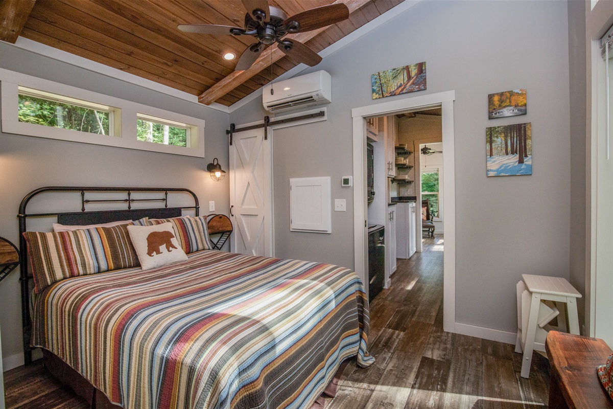 A plush queen bed, soft linens, and space for your belongings—comfort at the heart of your stay.