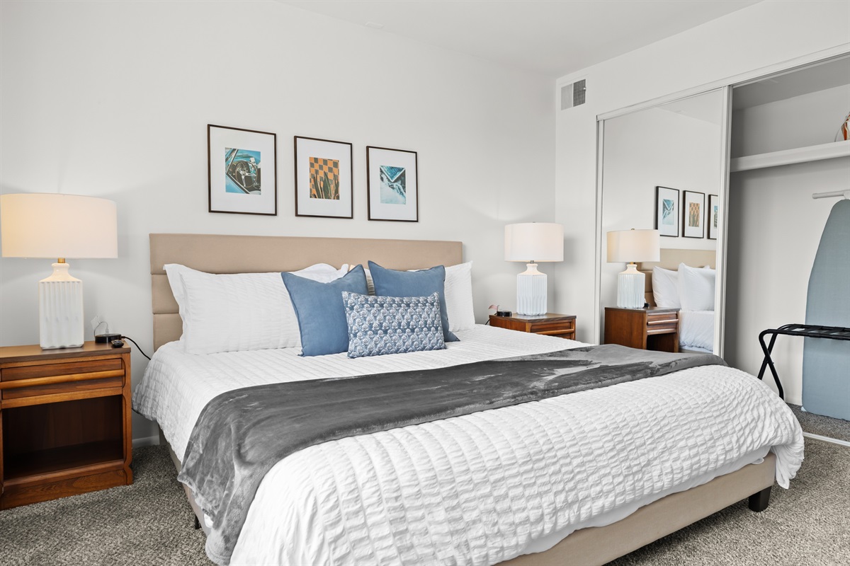 Relax in this tranquil haven, complete with a king-size bed and a stylish wood-paneled accent wall.