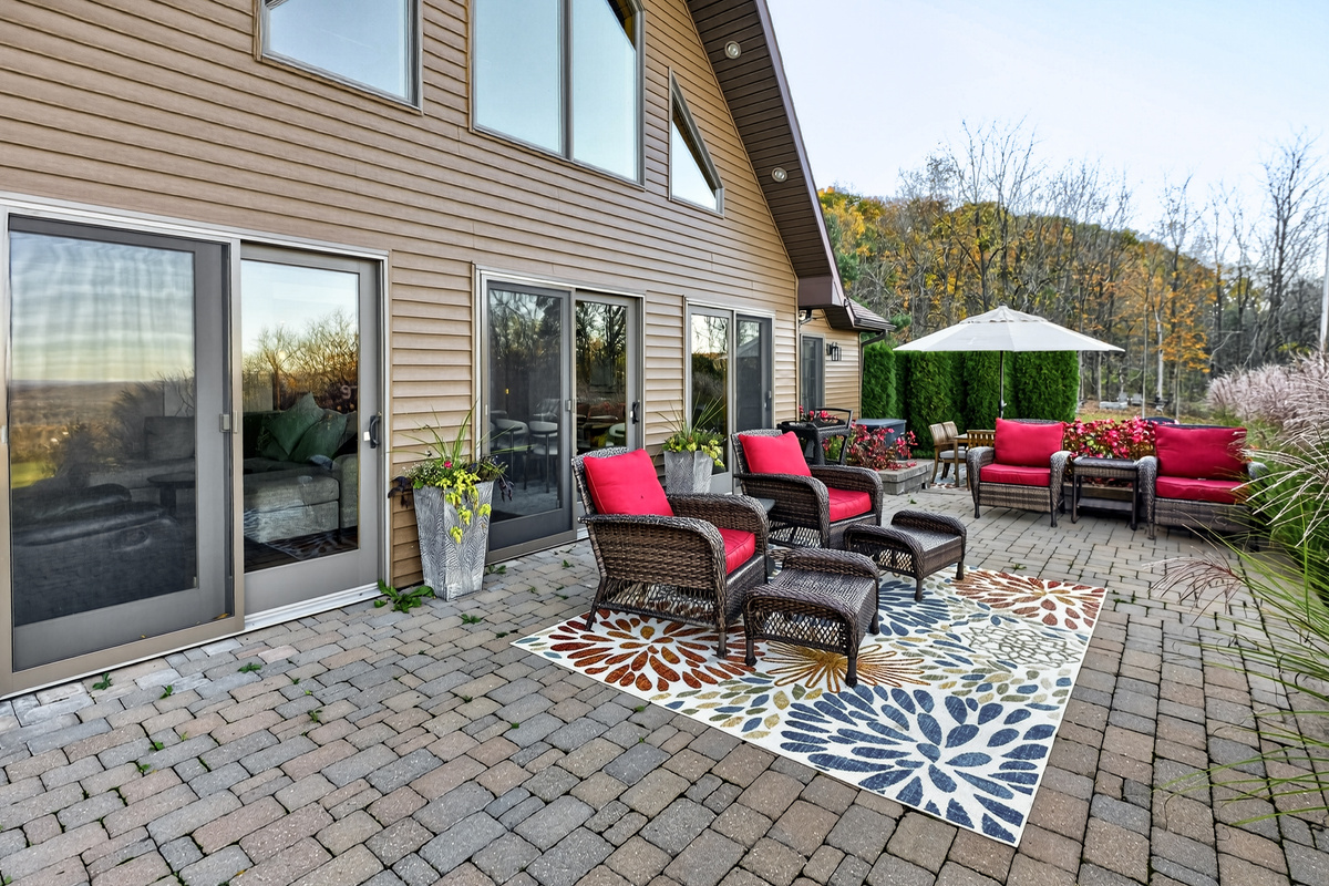 Spacious stone patio with multiple seating areas