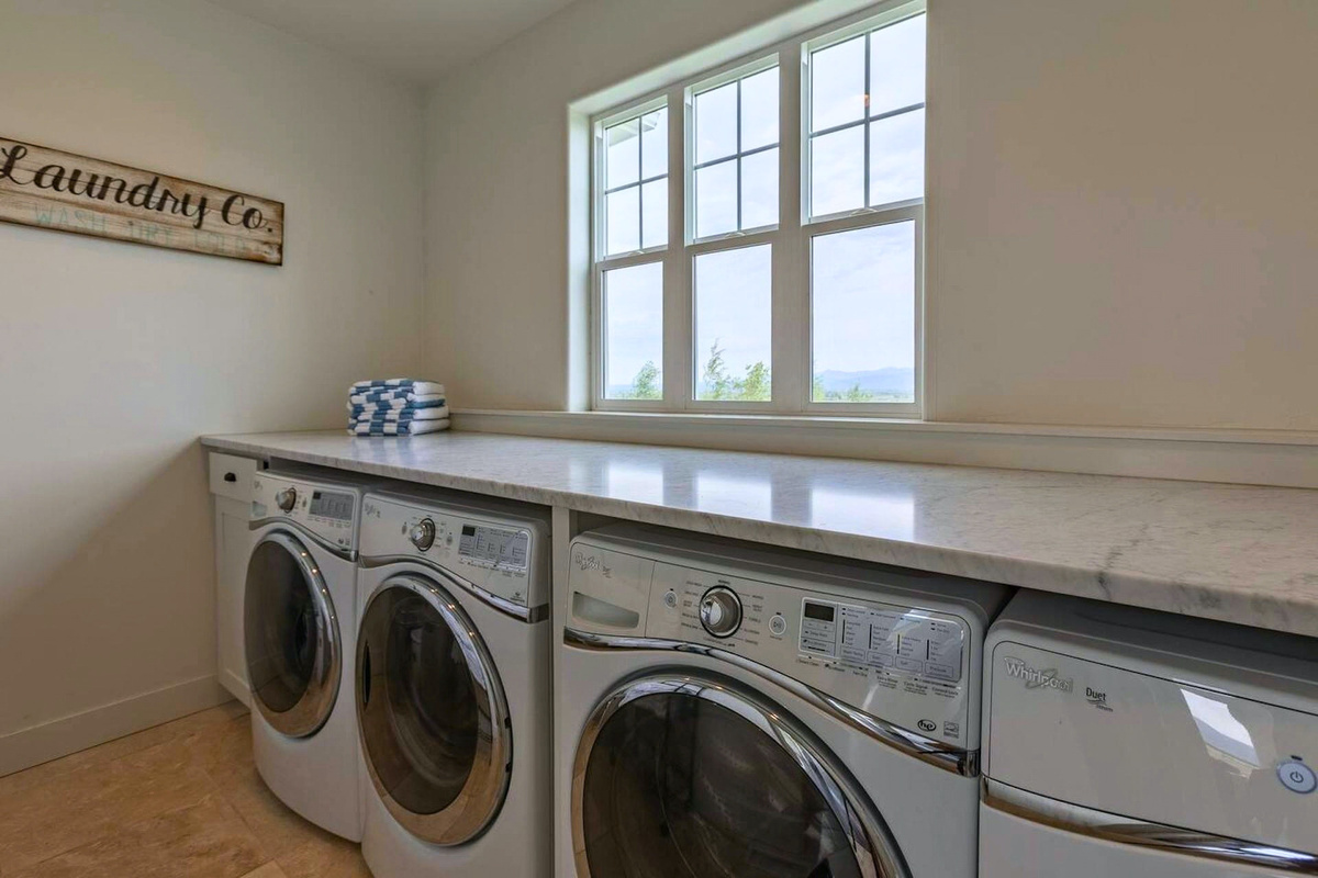 Laundry area with multiple machines to handle group stays with ease