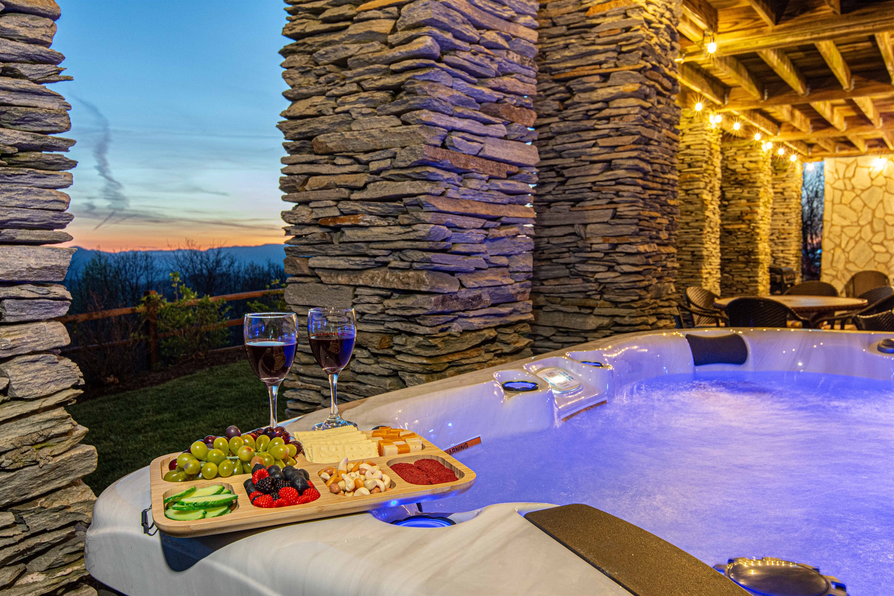 Hot Tub: Unwind with stunning views and a charcuterie spread under twinkling lights!