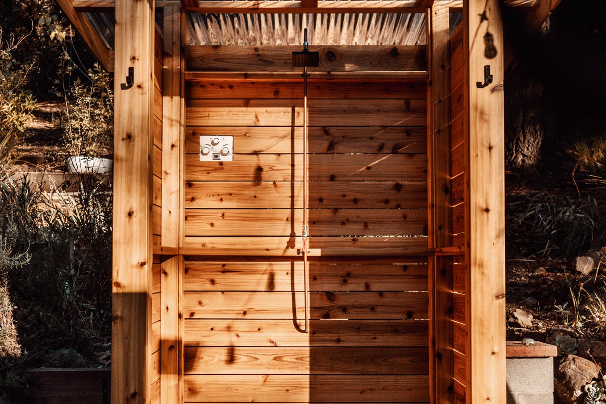Outdoor shower under the trees, a refreshing start to your day.”