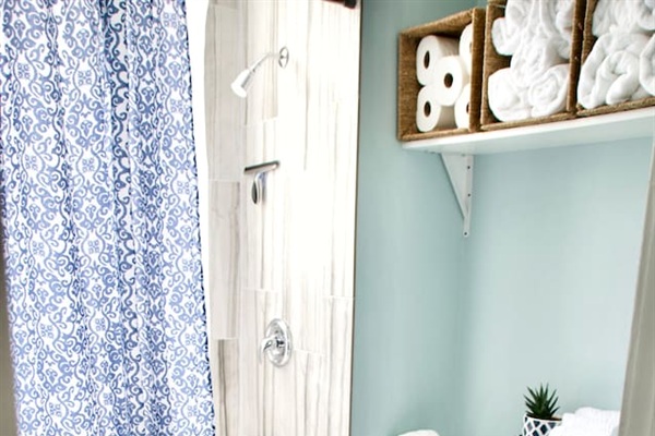 Clean bathroom with shower and fresh towels provided for your stay.