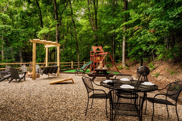 Outdoor Oasis with Dining, Fire Pit, Swings, Playground, and Yard Games—Perfect for Families to Gather and Play.