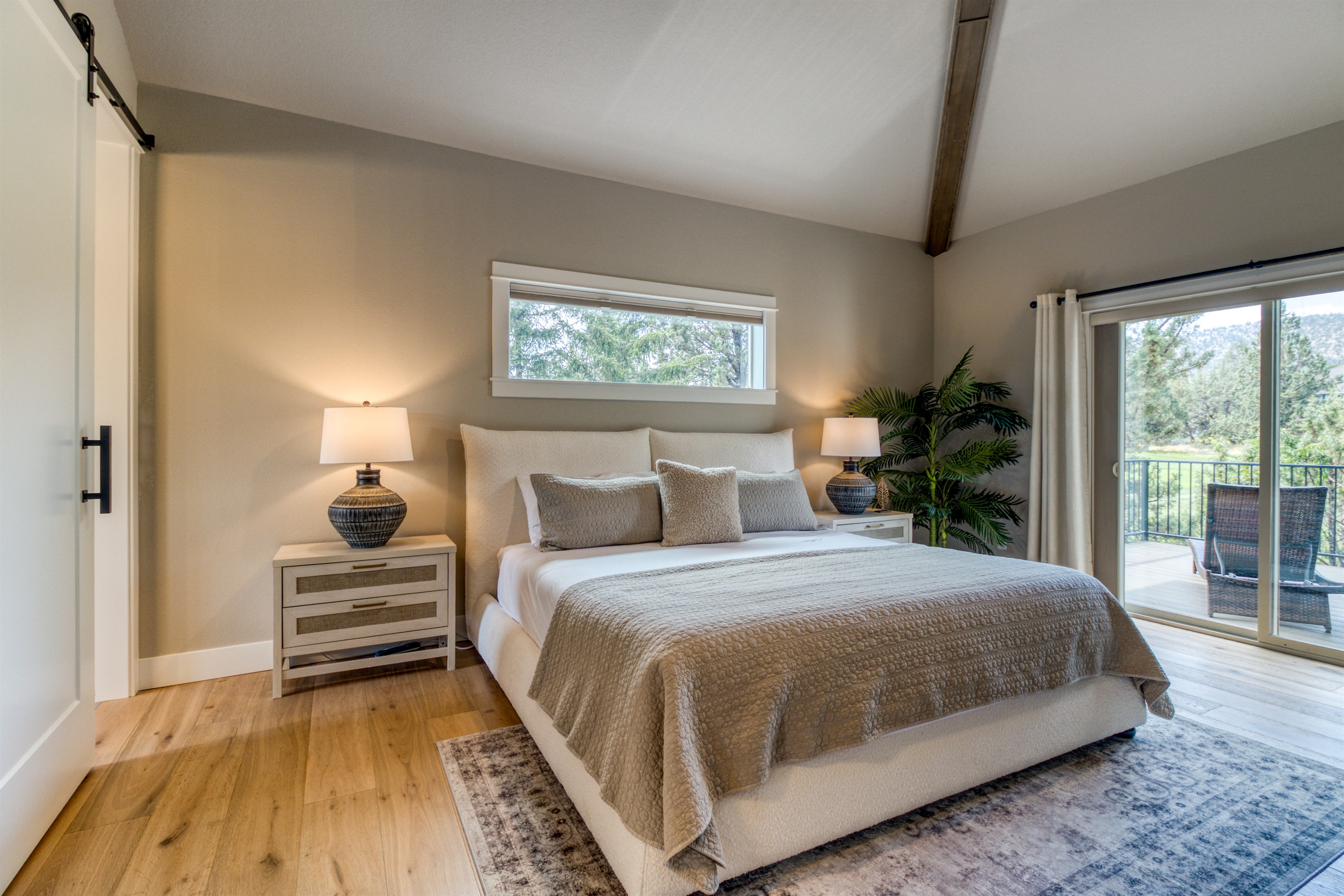 King Bedroom #1 offers a dreamy night's sleep, private bathroom & deck access.