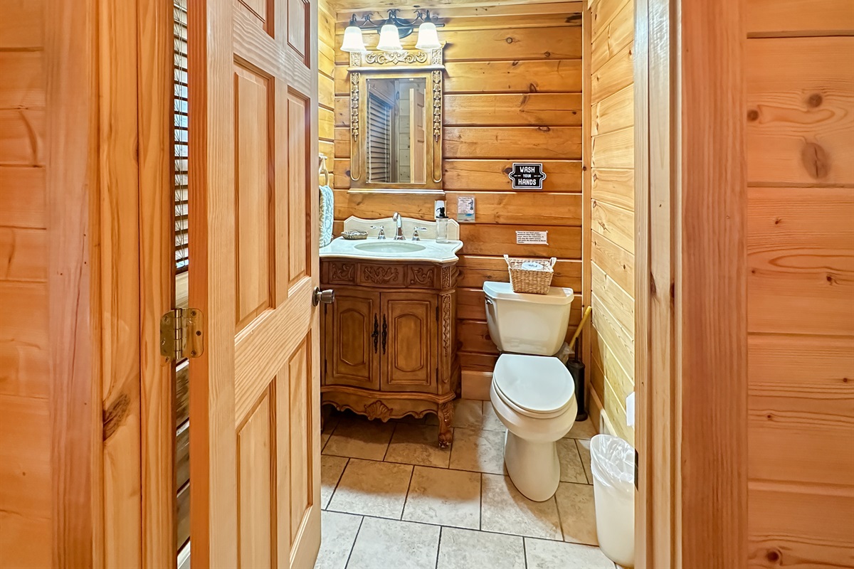 Bathroom 1: Rustic elegance with wooden accents and modern amenities for your refreshing escape!