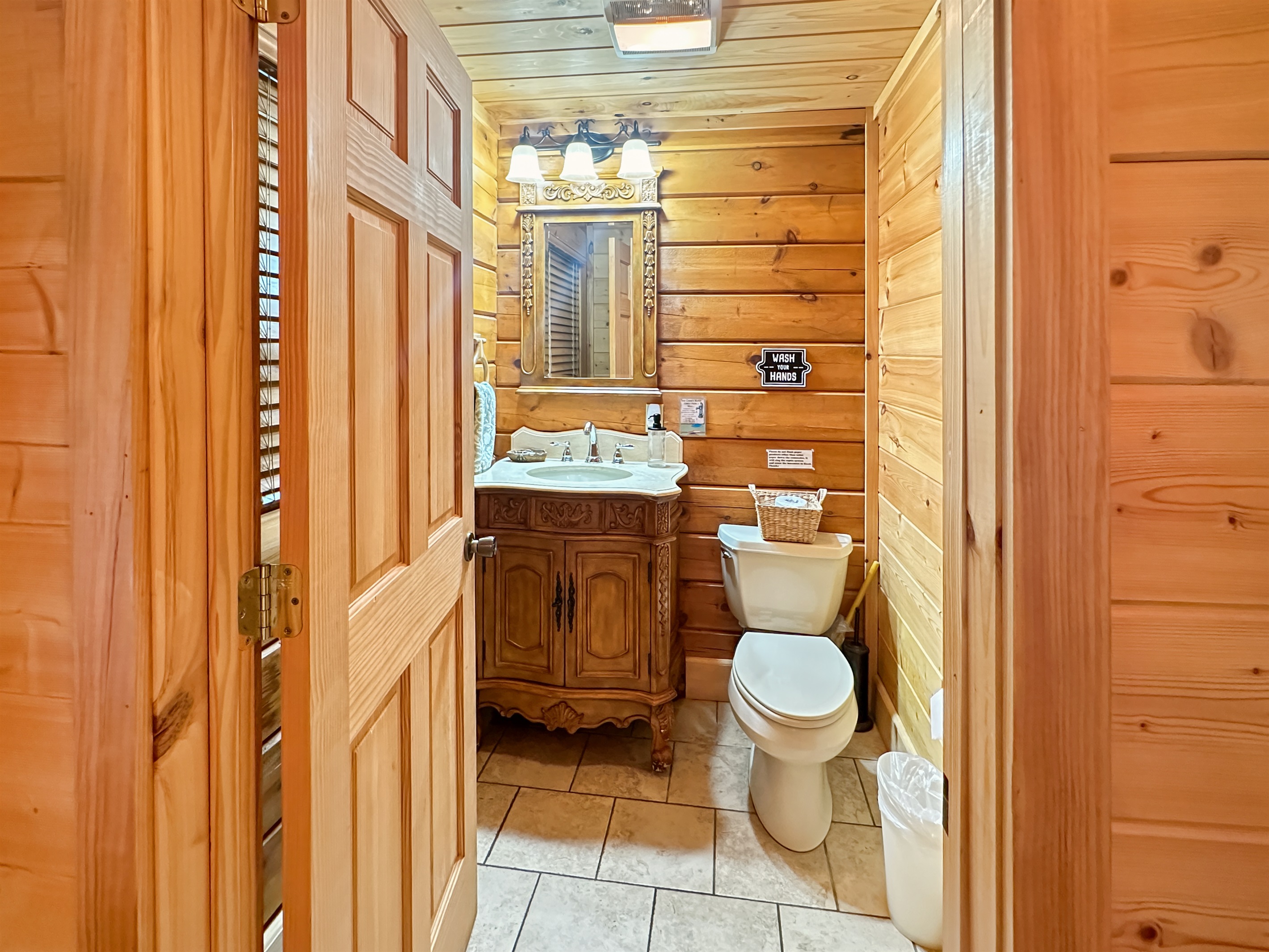 Bathroom 1: Rustic elegance with wooden accents and modern amenities for your refreshing escape!