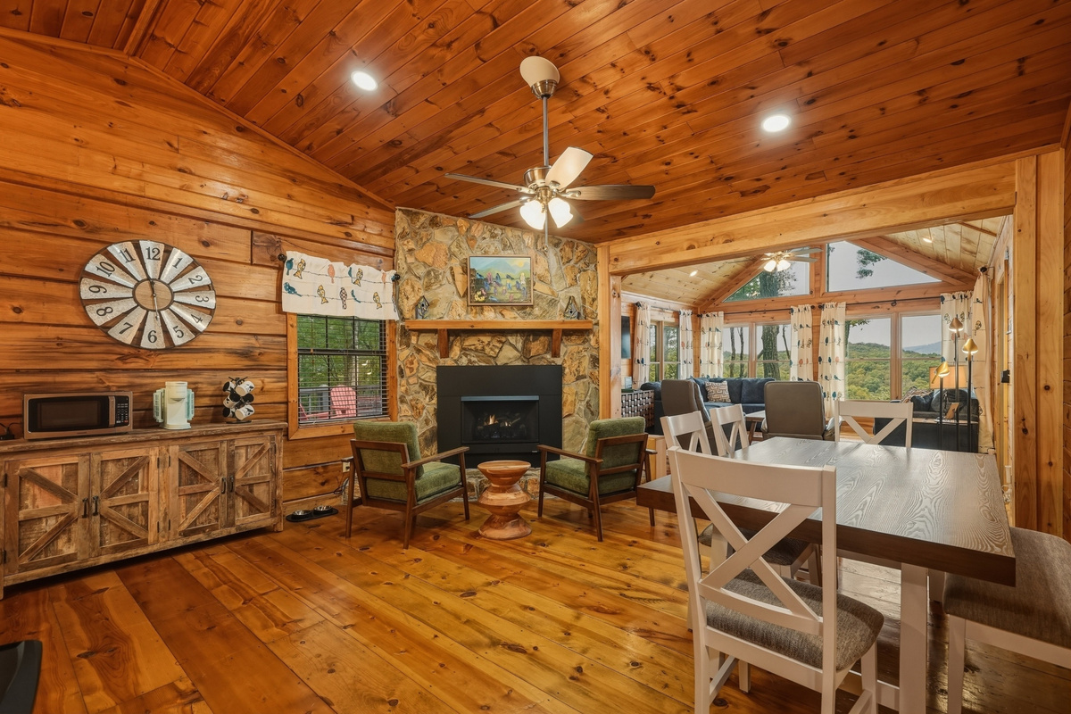 Living area with lots of seating, fire place and smart TV