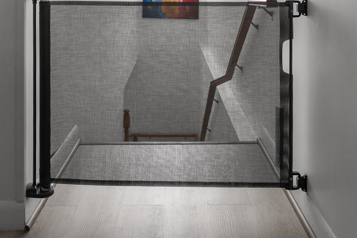 Retractable child gate at staircase landing