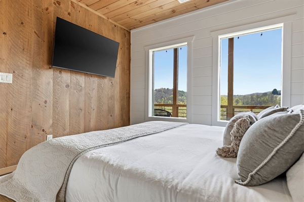 Unwind in comfort with a ceiling fan and 55” wall-mounted TV. This bedroom also includes a private closet equipped with a box fan and luggage rack — perfect for white noise and convenient unpacking after your travels.