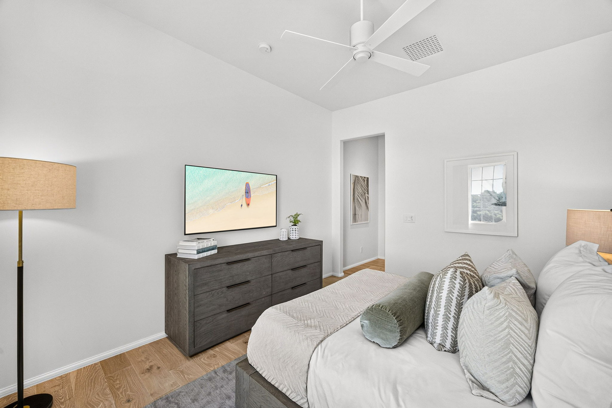 Guest Suite #2 offers a large dresser, wall-mounted Smart TV, a large closet for your clothes, and an ensuite bath with walk-in shower.