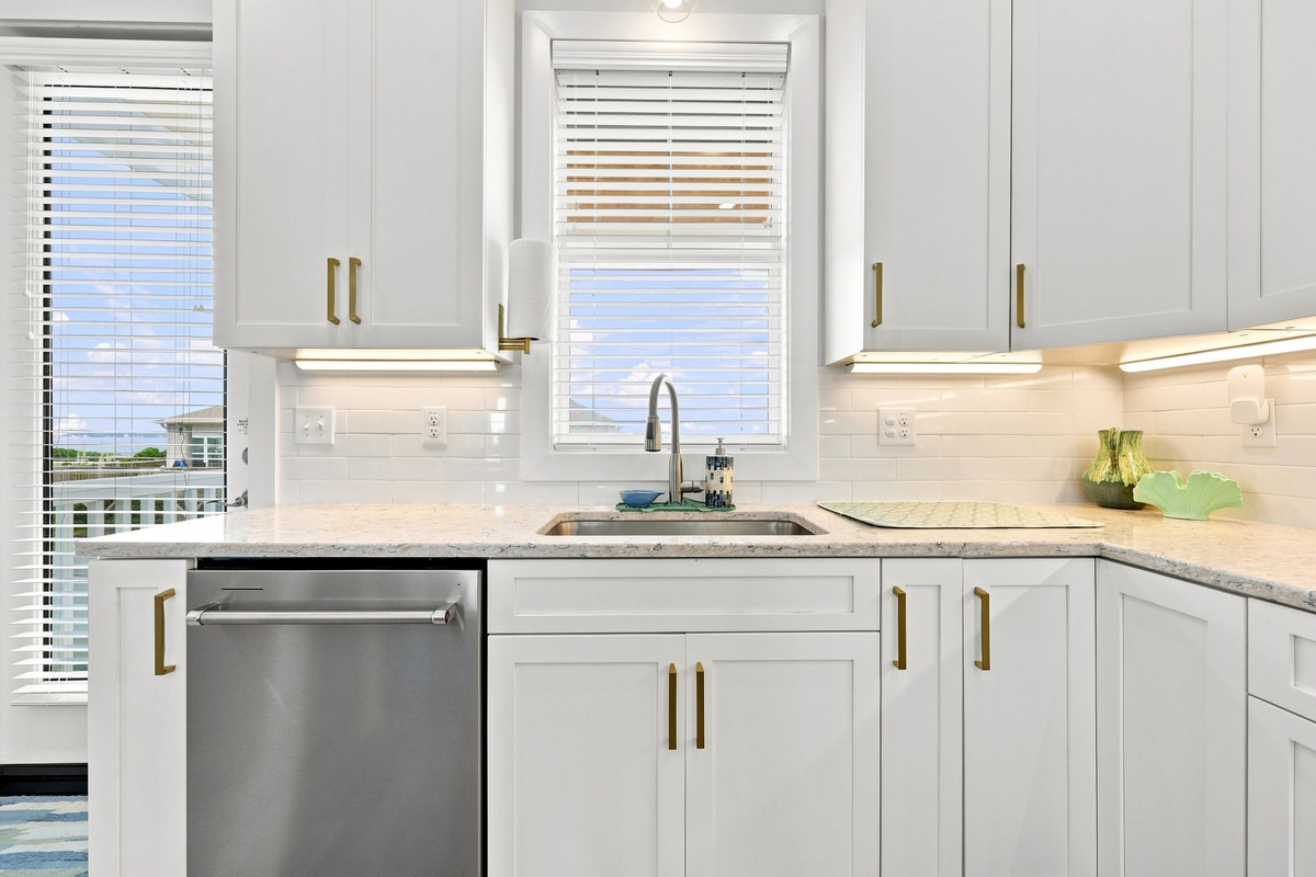 A bright and modern kitchen with spacious countertops, quality finishes, and everything you need to prepare meals during your coastal getaway