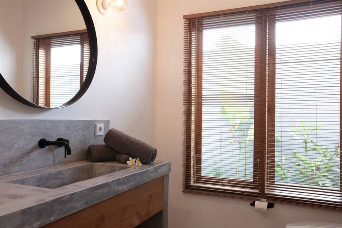 An elegantly integrated window in the bathroom, bringing soft natural light into your space.