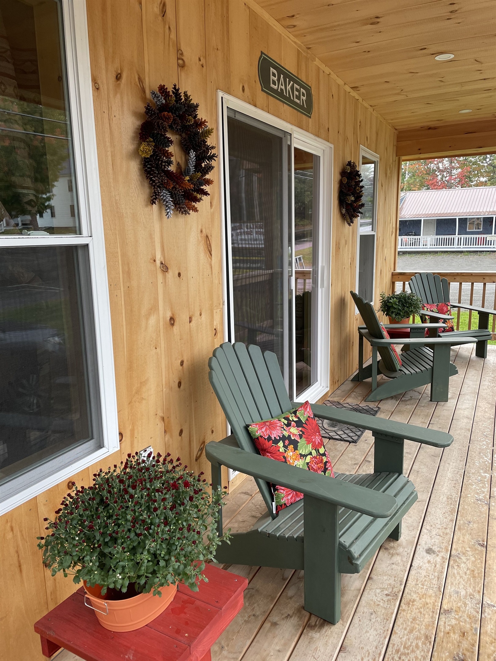 Front porch with Adirondack chairs to relax with access to restaurants and shops