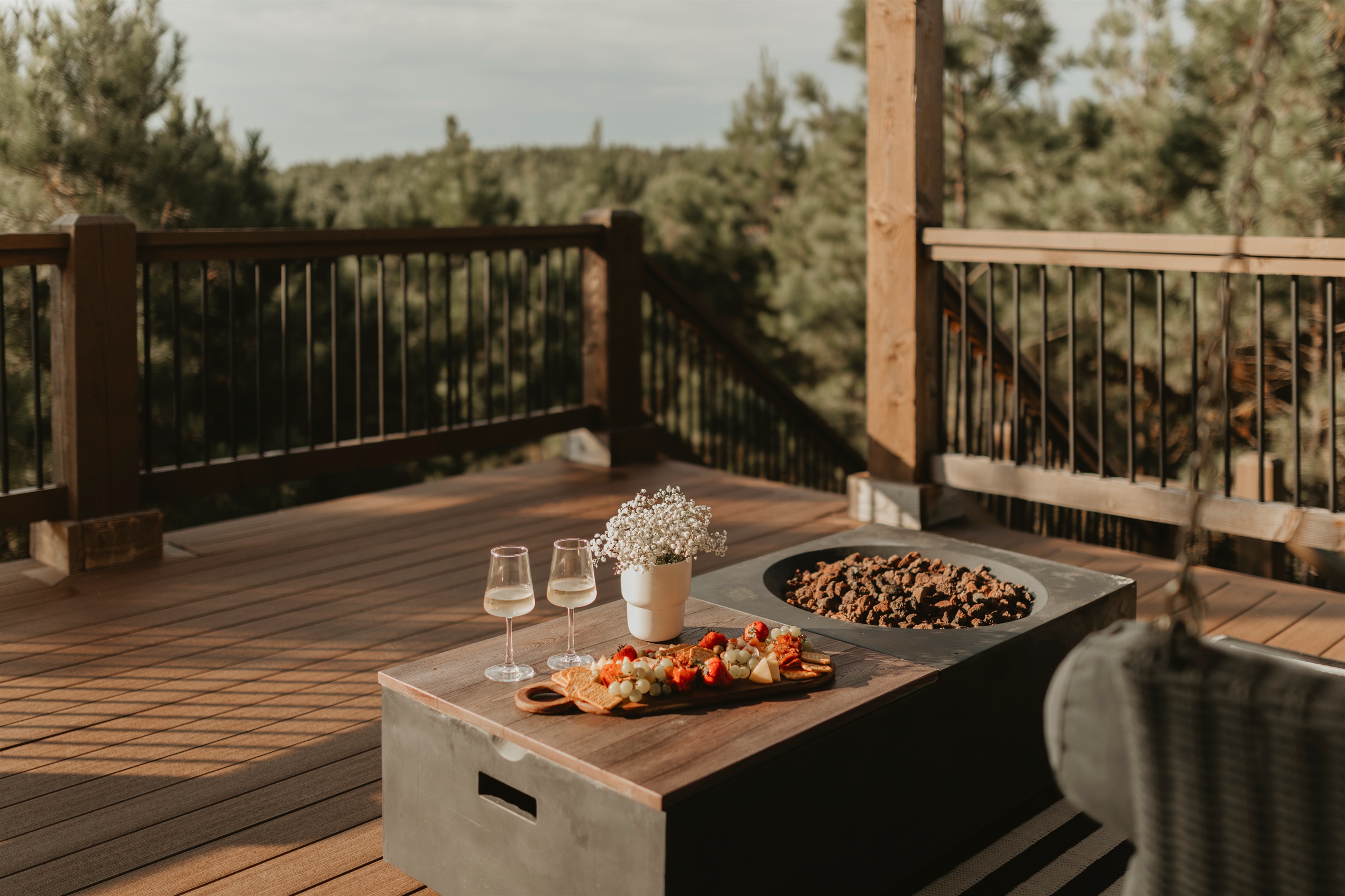 Your favorite romantic evenings are spent enjoying stunning sunsets and sweeping views for miles, by the fire table on the upper deck with optional charcuterie available during your stay.