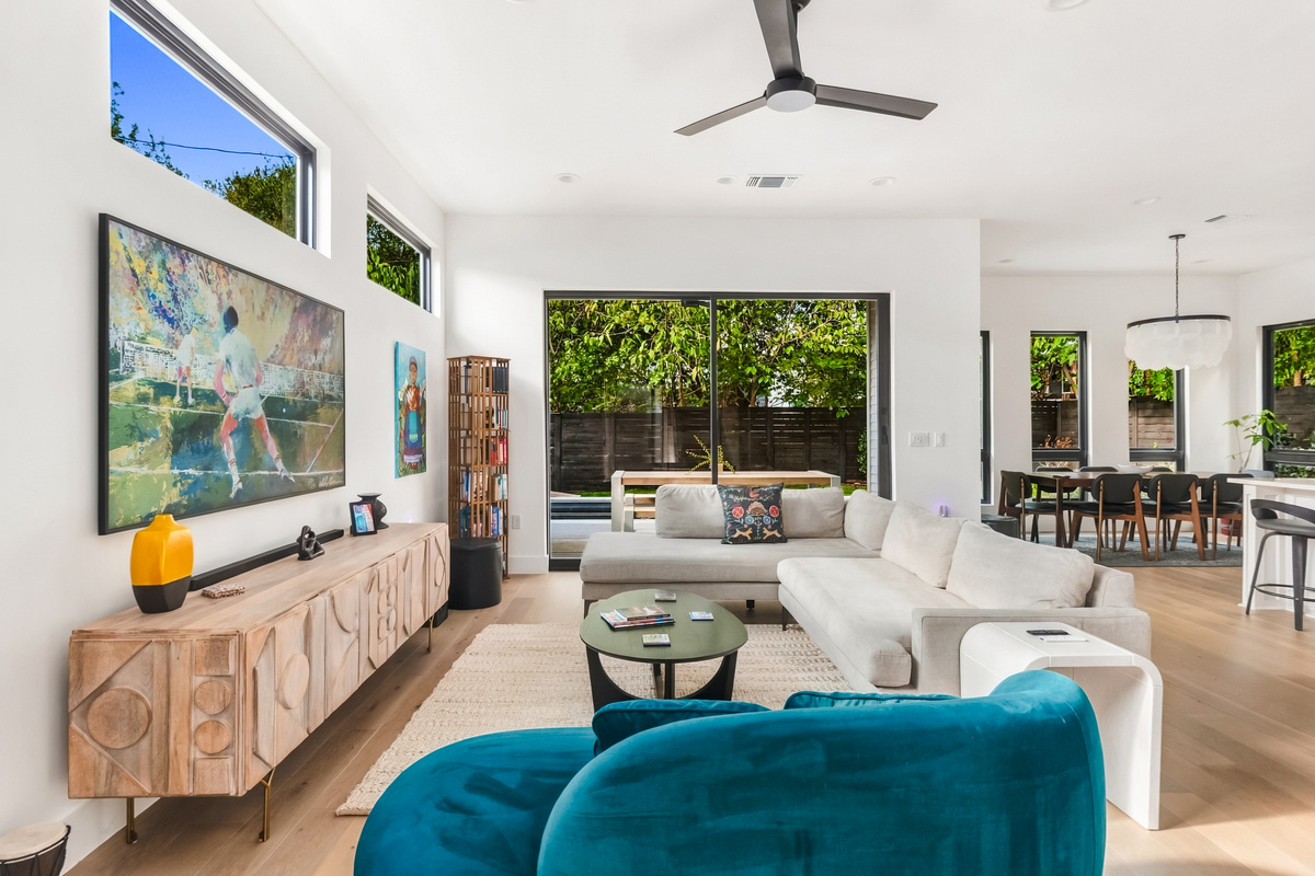 Plush sectional and teal accent chairs create a comfortable spot to unwind.