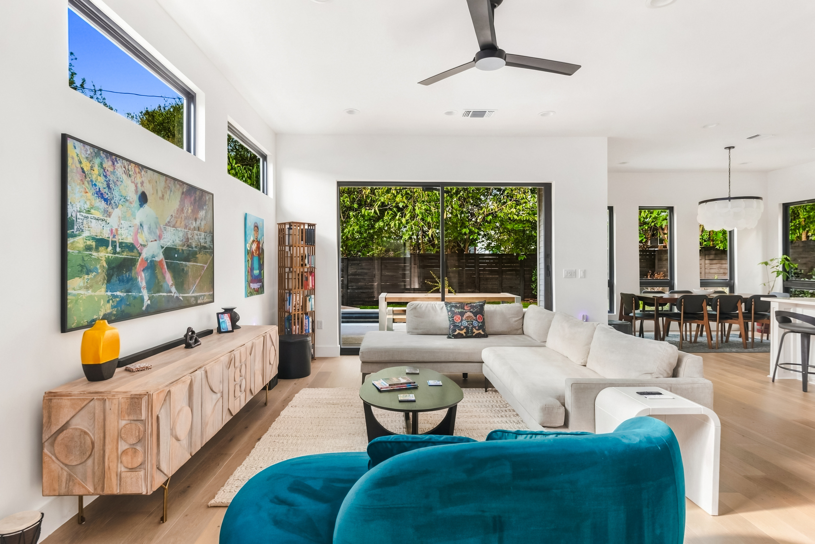 Plush sectional and teal accent chairs create a comfortable spot to unwind.
